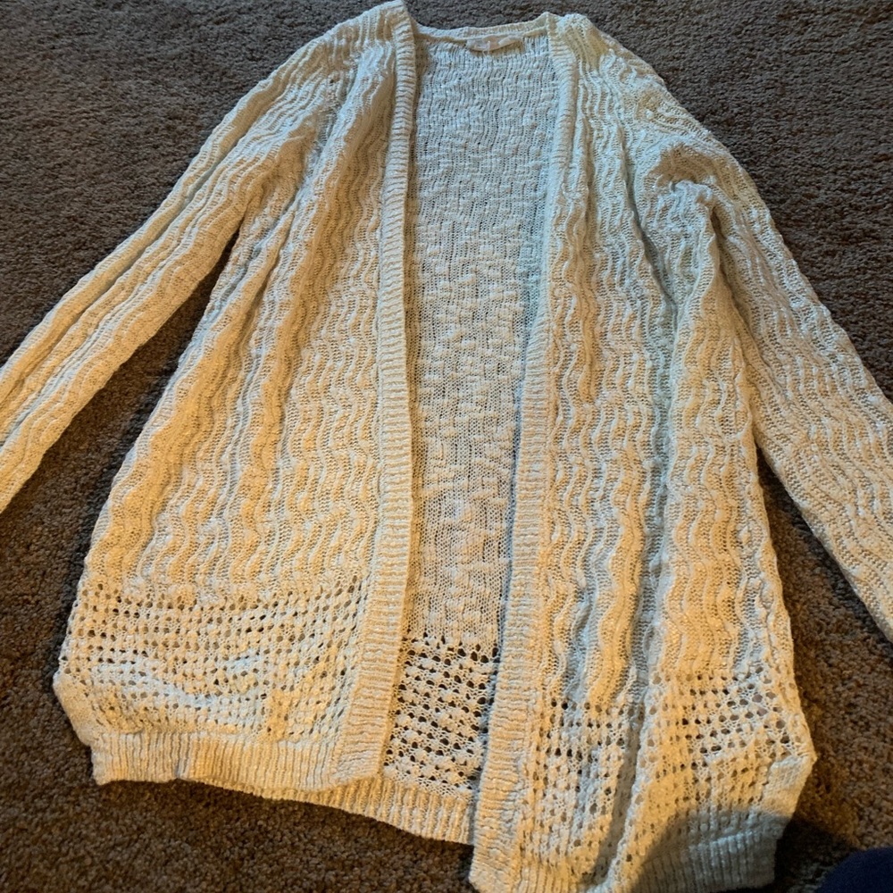 White/cream colored cover up shirt.